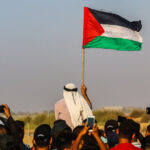 A protester holds a flag of Palestine during the