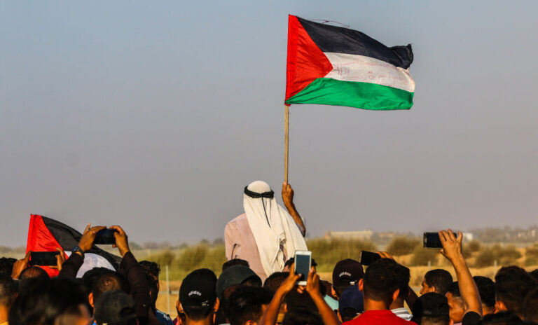 A protester holds a flag of Palestine during the