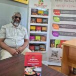 Nazir Malek with some of the curries in a box that he devised.