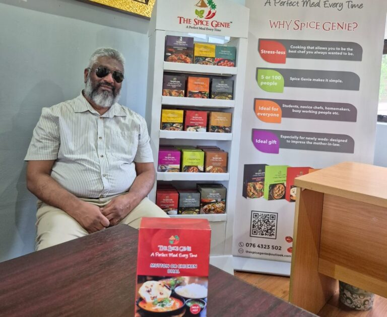 Nazir Malek with some of the curries in a box that he devised.